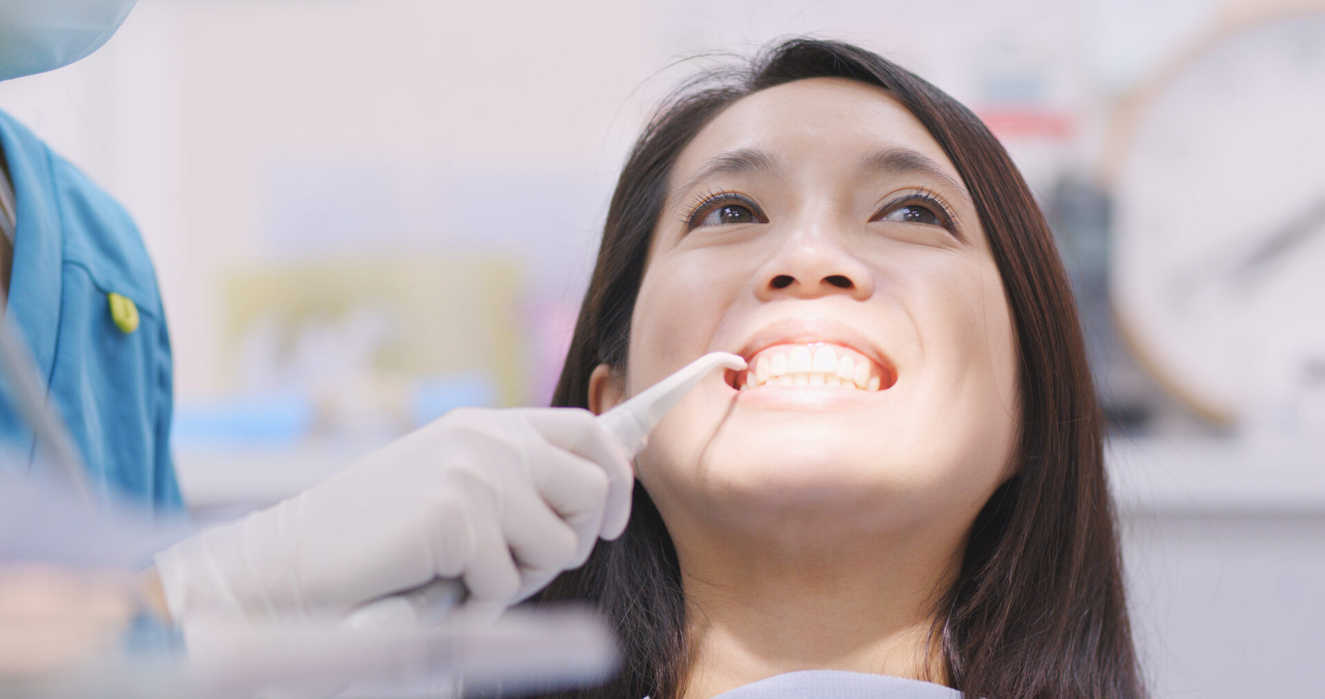 Woman dentist working at her patients teeth
